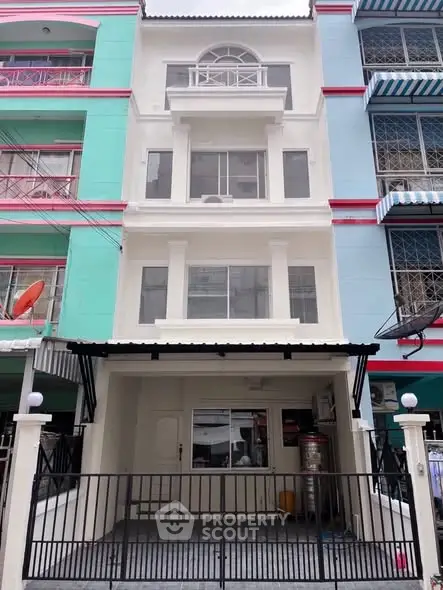 Charming multi-story townhouse with gated entrance and modern facade