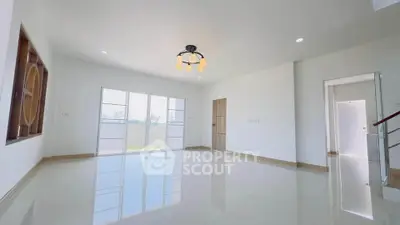 Spacious and bright living room with modern lighting and glossy floors.