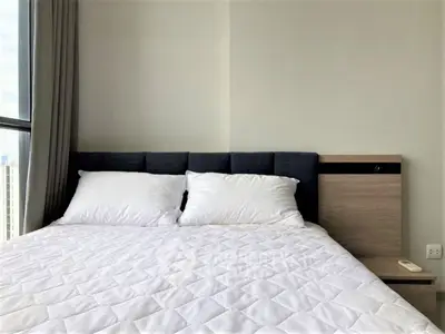 Modern bedroom with large window and stylish bed in urban apartment