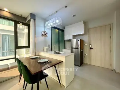 Modern kitchen with sleek design, featuring stainless steel appliances and stylish dining area.