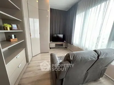 Modern living room with sleek furniture and large windows offering ample natural light.