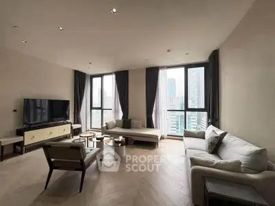 Spacious modern living room with large windows and city view, featuring elegant furniture and neutral tones.