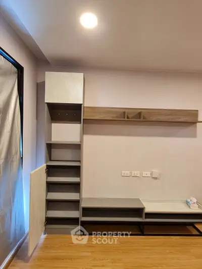 Modern living room with built-in storage and sleek wooden flooring