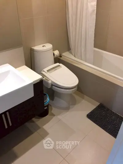 Modern bathroom with sleek fixtures and a bathtub, perfect for relaxation.