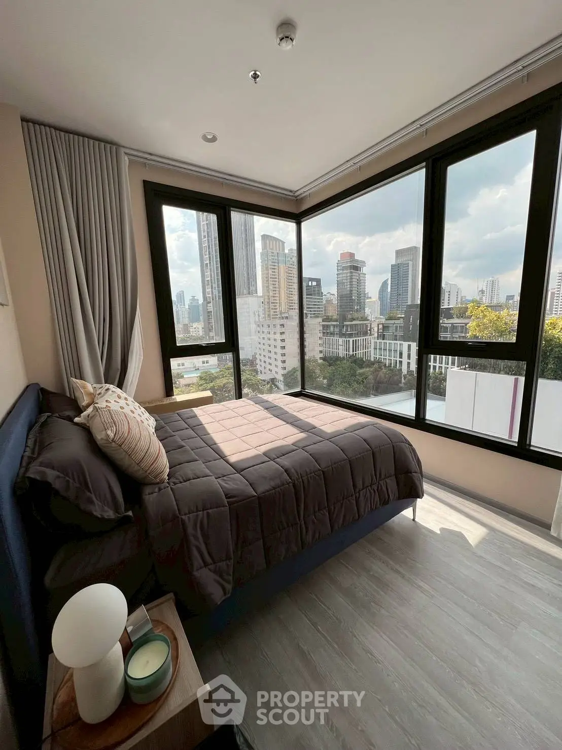 Modern bedroom with stunning city view and large windows