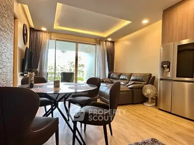 Spacious living room with modern furniture and large windows for natural light.