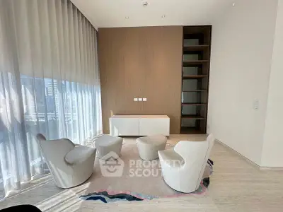 Modern living room with stylish chairs and floor-to-ceiling windows