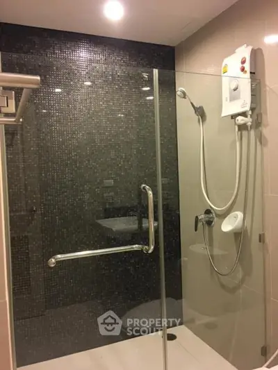 Modern bathroom with glass shower enclosure and sleek tile design