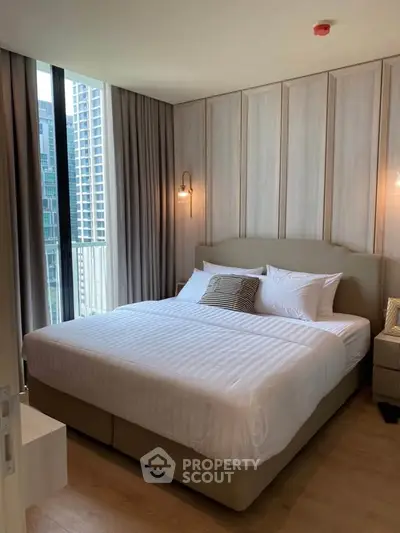 Luxurious bedroom with modern decor and city view in high-rise apartment