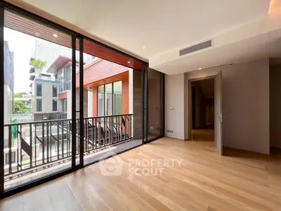 Spacious modern room with large windows and balcony view