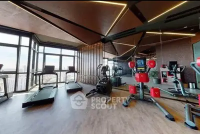 Luxurious high-rise gym with panoramic city views and modern fitness equipment.