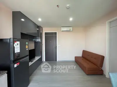 Modern living room with sleek black cabinetry and brown leather sofa