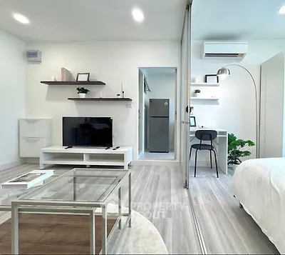 Modern studio apartment with sleek design and open layout, featuring a cozy living area and stylish decor.