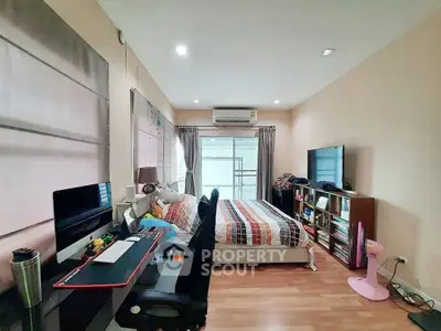 Spacious bedroom with modern workspace and cozy decor