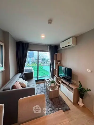 Modern living room with cozy sofa, TV, and large window offering city view.