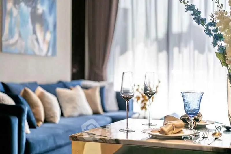 Luxurious living room with elegant decor and plush blue sofa, perfect for modern living.