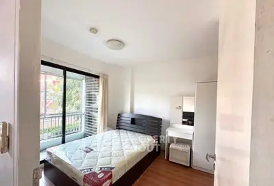 Bright bedroom with balcony access and modern furnishings