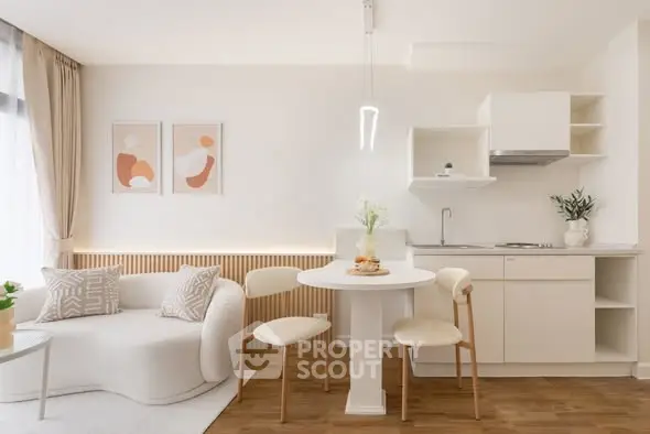 Modern open-plan living room and kitchen with elegant decor and natural light.