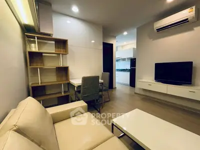 Modern living room with sleek furniture and open kitchen layout