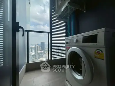 High-rise balcony with washing machine and stunning city view