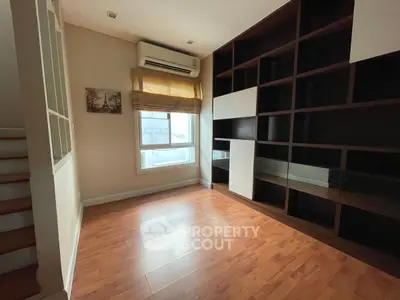 Spacious study room with built-in shelves and natural light
