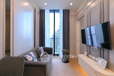 Modern living room with sleek design and city view from balcony.