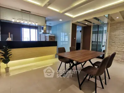 Modern dining area with stylish lighting and glass partitions