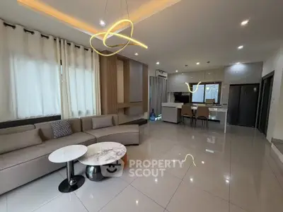 Spacious modern living room with elegant lighting and open kitchen layout