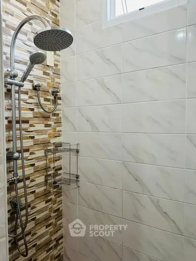 Modern bathroom shower with stylish tile design and rainfall showerhead
