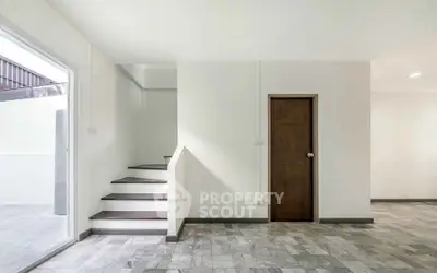 Modern minimalist interior with staircase and wooden door