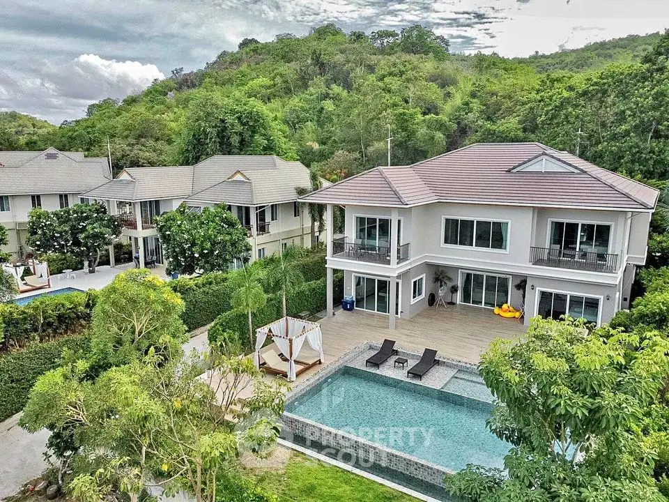 Luxurious villa with private pool and lush garden in serene hillside setting