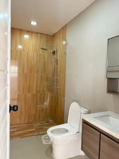 Modern bathroom with wood accents and glass shower enclosure