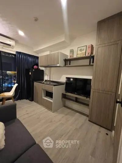 Modern compact living room with integrated kitchen and stylish decor