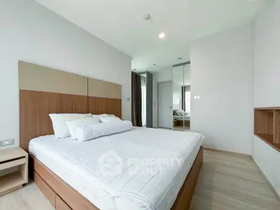 Spacious modern bedroom with minimalist design and ample natural light