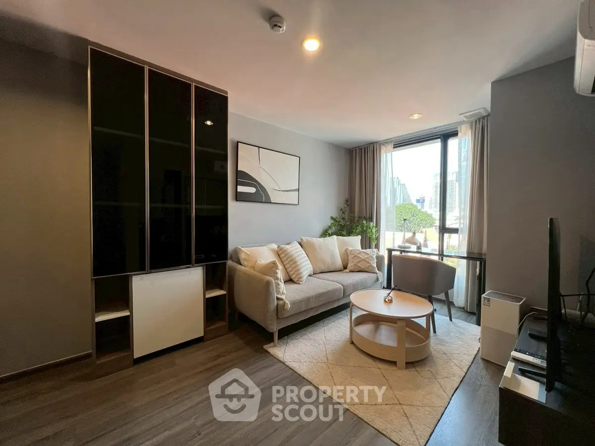 Modern living room with stylish furniture and city view, perfect for urban living.