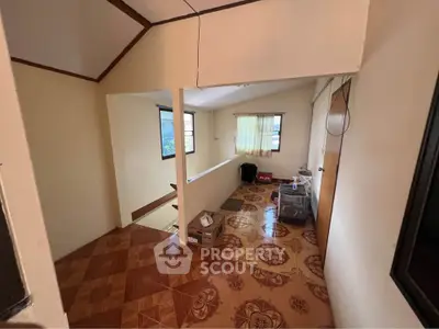 Cozy interior space with patterned flooring and natural light, ideal for creative renovation.