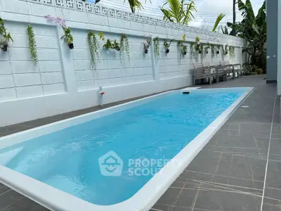 Charming backyard with sleek pool and lush greenery, perfect for relaxation and entertaining.