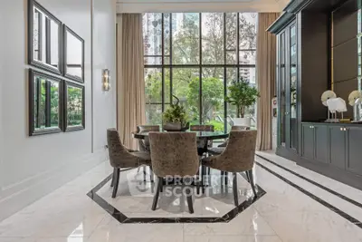Luxurious dining area with elegant decor and large windows overlooking greenery.