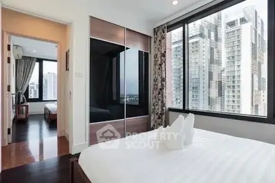 Modern bedroom with city view and stylish decor in high-rise apartment