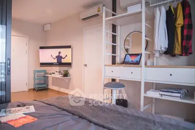 Modern bedroom with stylish decor, wall-mounted TV, and organized storage solutions.