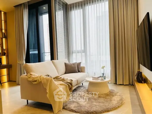 Luxurious modern living room with elegant sofa and floor-to-ceiling windows.