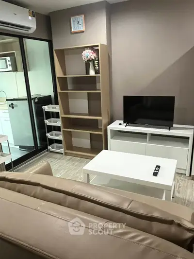 Modern living room with sleek furniture and kitchen view