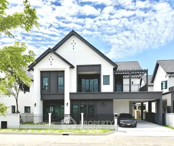 Stunning modern two-story house with sleek design and spacious driveway in a serene neighborhood.