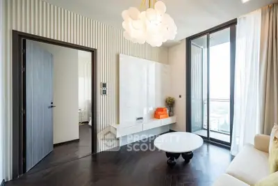 Modern living room with elegant decor and large windows offering stunning city views.