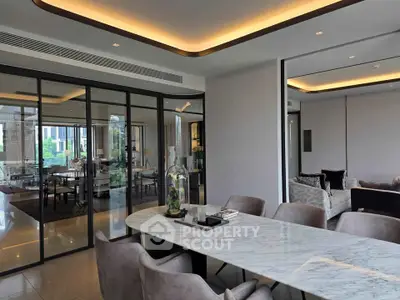 Luxurious modern dining area with marble table and elegant decor in a high-end apartment.