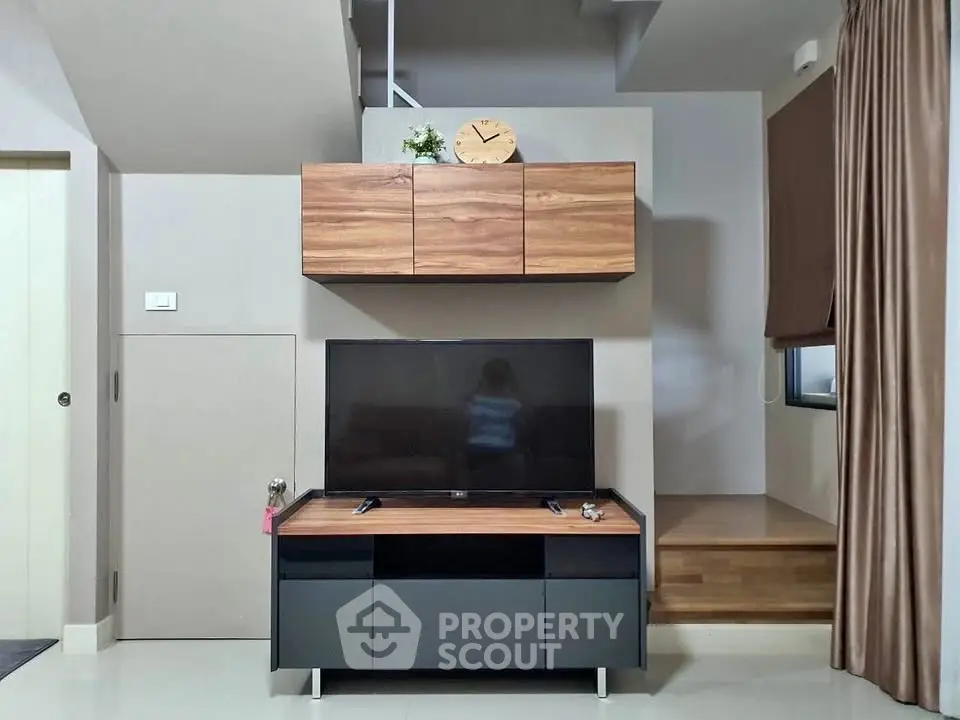 Modern living room with sleek TV stand and wooden cabinets
