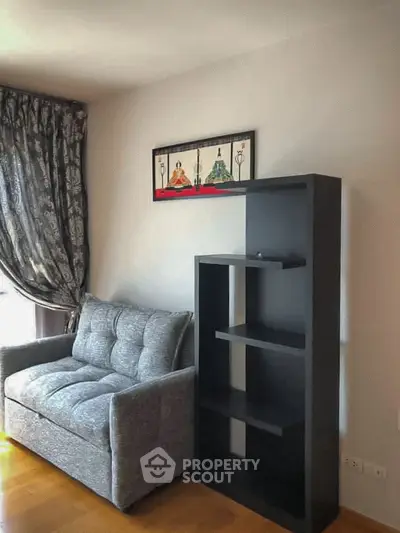 Cozy living room with stylish sofa and modern shelving unit, perfect for relaxation and storage.