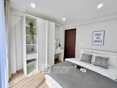 Modern bedroom with stylish decor and ample natural light