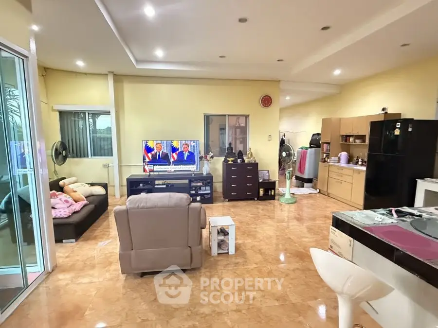 Spacious living room with modern furniture and open kitchen layout