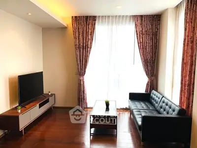 Spacious living room with modern decor and large window for natural light.